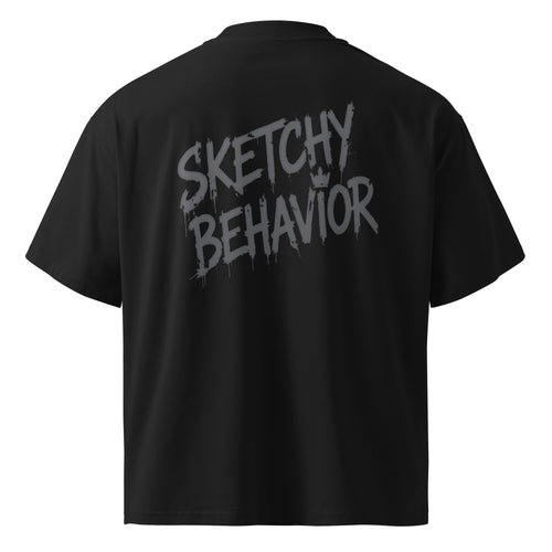 Blaster 2.0 unisex organic oversized high-neck t-shirt in Black, back view — large tonal "Sketchy Behavior" spray-style wordmark across the back